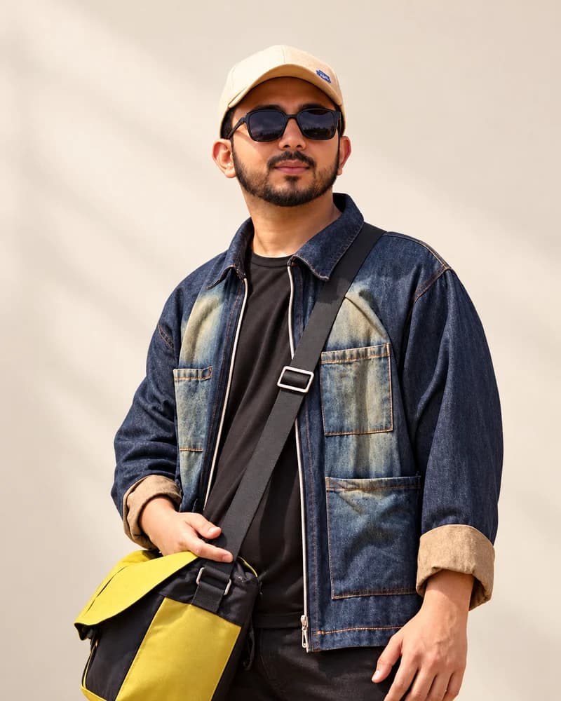 Muhammad Kashif wearing a denim jacket, cream cap and sunglasses